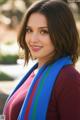 A beautiful young woman wearing a blue and red scarf.